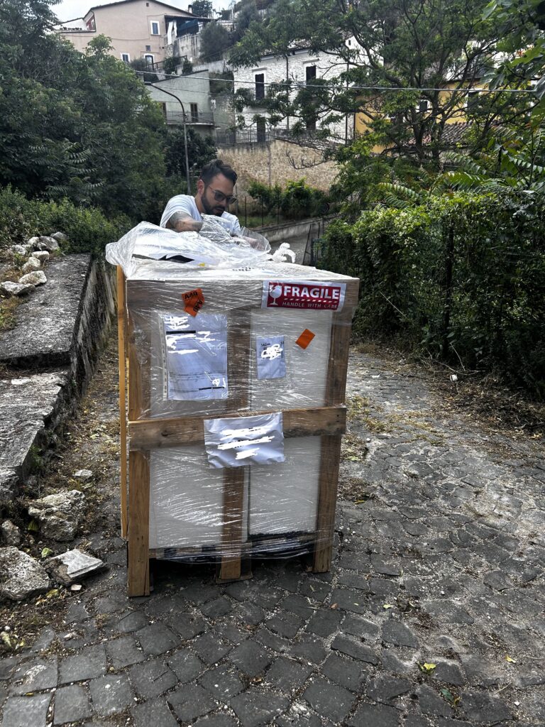 Delivery of a wood oven in a crate to an Italian home during a kitchen renovation.