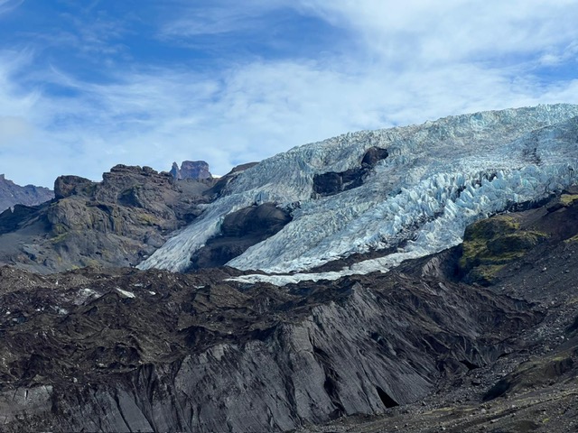 Icelandic glacier flowing between rugged mountains during our Iceland Ring Road trip.