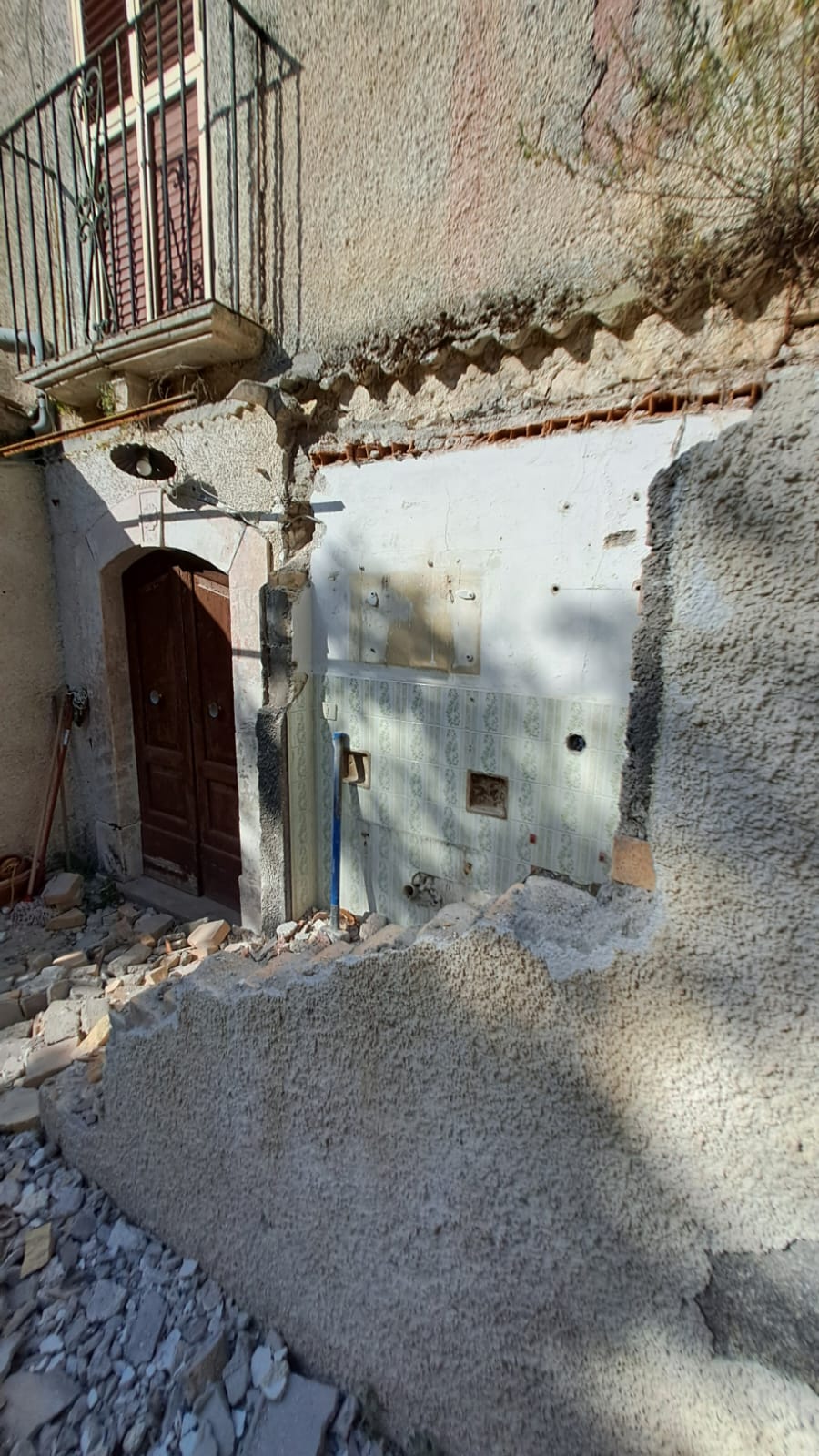 Bathroom walls and fixtures being demolished inside our old Italian house