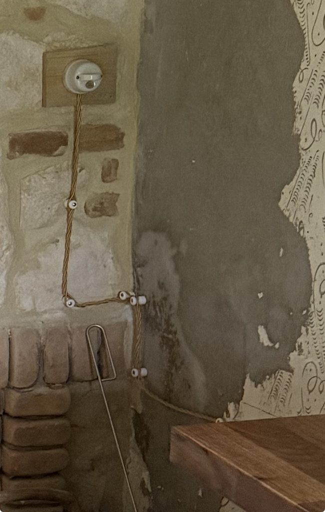 Exposed porcelain electrical wiring and ceramic switch for our wood-burning bread oven installation.