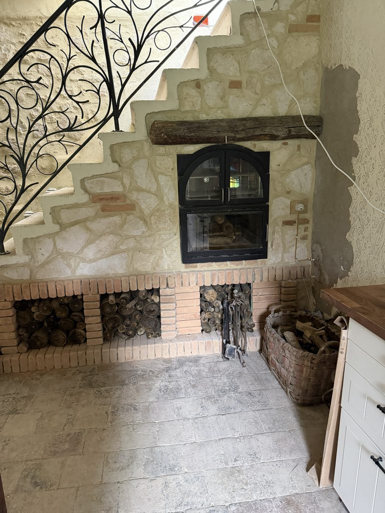 Completed limestone and brick surround built around the wood-burning bread oven in our Italian kitchen.