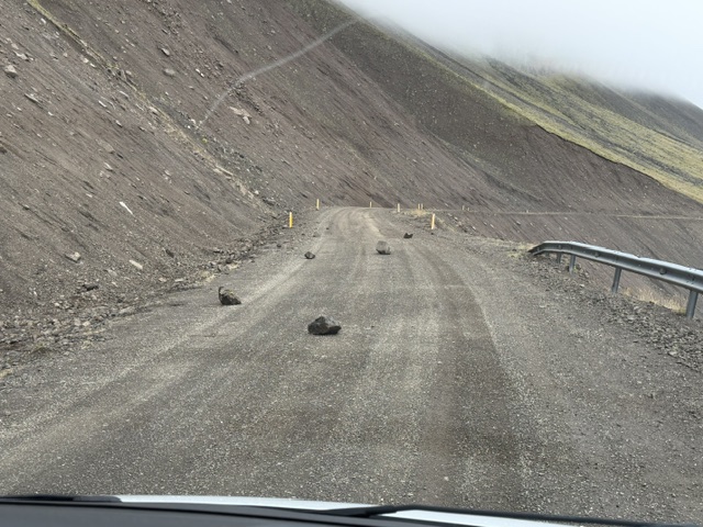 Large boulders scattered across a remote dirt road, hindering our Iceland Ring Road expedition.