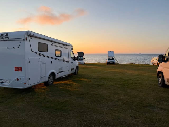 Our campervan parked overnight at an Iceland campsite as the sun sets during our Ring Road trip.