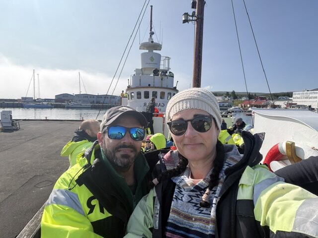 Standing in front of Iceland’s longest wooden vessel before our whale watching expedition.