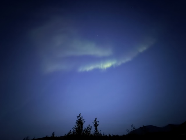 Aurora borealis illuminating the Icelandic night sky during our campervan trip.