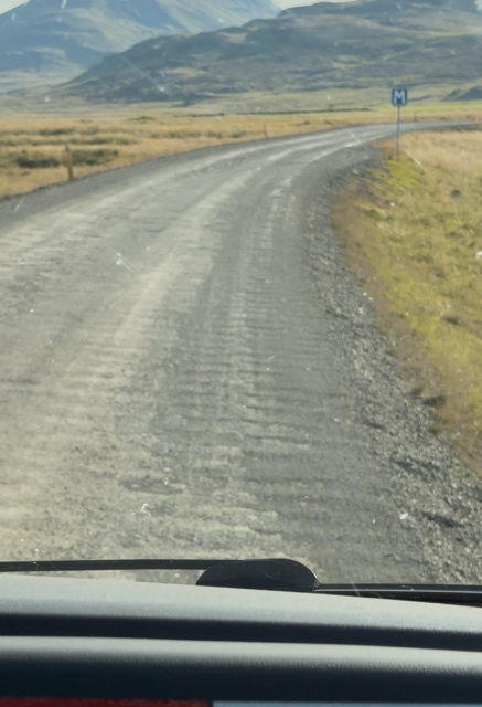 Tank tracks running along a rough dirt road during our Iceland Ring Road campervan trip.