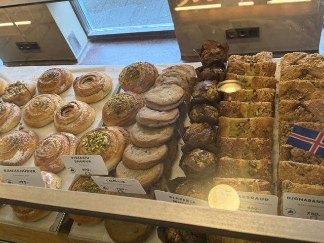 Close-up of a cinnamon roll covered in sweet icing at a Reykjavík bakery